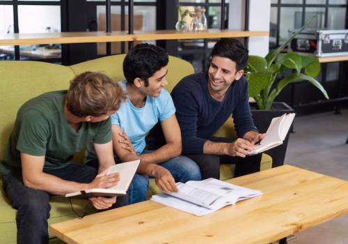 three-relaxed-fellow-students-studying-chatting_1262-15305